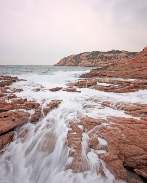 Rocky sea coast and blurred water — Stock Photo, Image