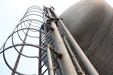 Stainless steel stairway in the tanks of a modern winery clipart