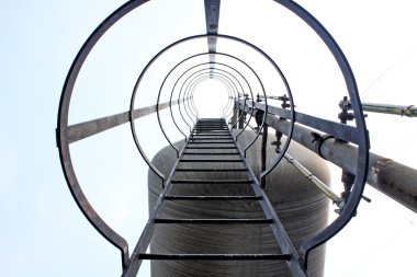 Stainless steel stairway in the tanks of a modern winery clipart