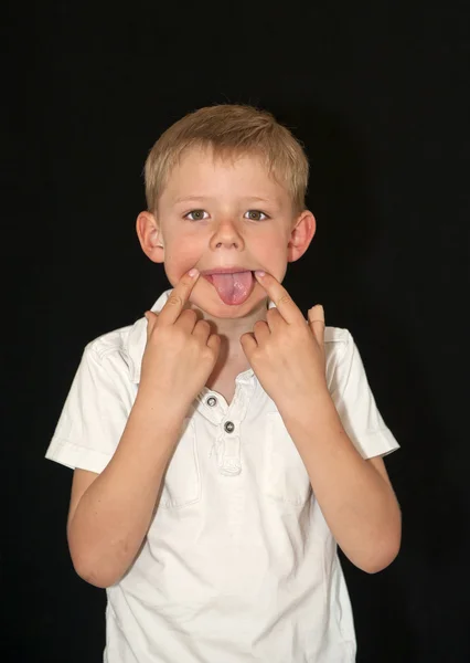 Imádnivaló, fiatal fiú húz egy vicces arc — Stock Fotó