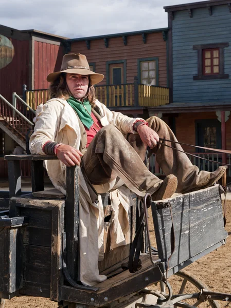 Cowboy sitting on his wagon — Stock Photo, Image