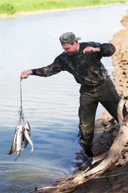 Fisherman gets out of the catch clipart