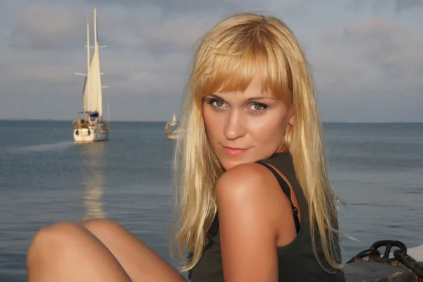 stock image Girl sitting on the beach