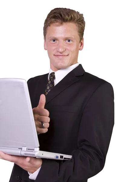 Empresario trabajando en el portátil y haciendo gestos con los pulgares hacia arriba — Foto de Stock