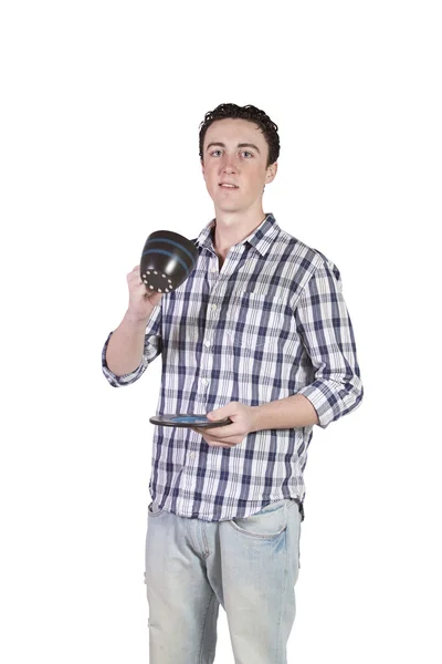 Young man standing while drinking coffee - white background — Stock Photo, Image