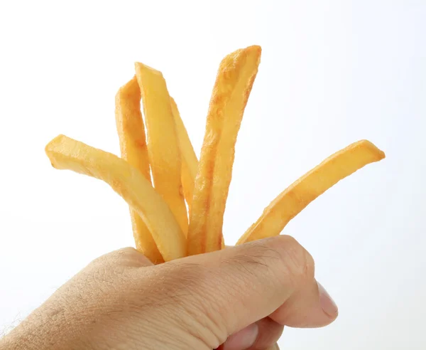 Mannens hand innehav pommes frites — Stockfoto