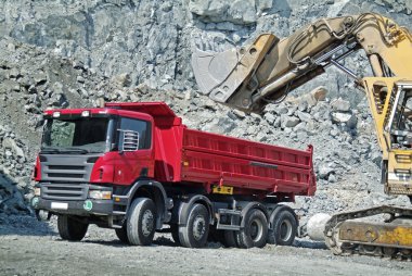 Dump Truck and Excavator in a Quarry clipart