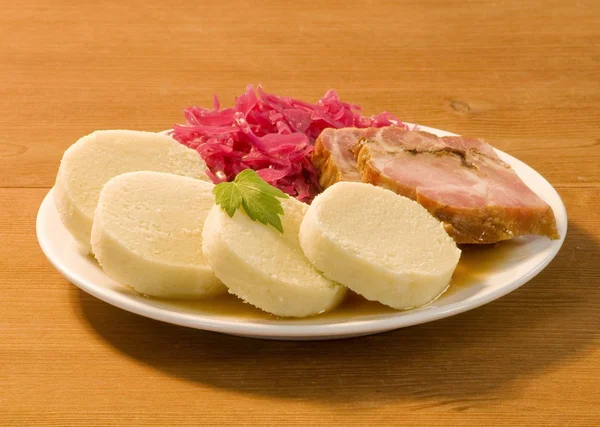 Roast pork, potato dumplings and red cabbage