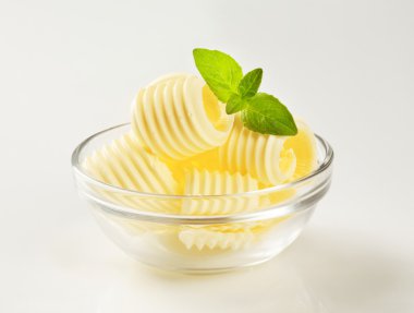Butter curls in a glass bowl clipart