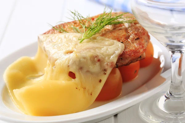 Marinated pork chop topped with cheese — Stock Photo, Image