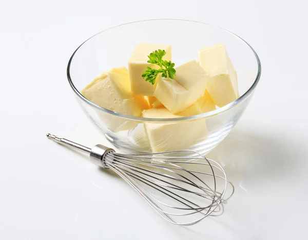 Fresh butter and whisk — Stock Photo, Image