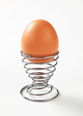 Egg in modern spiral metal egg cup clipart