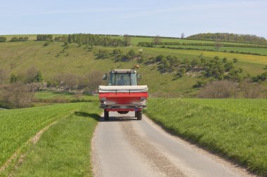 Tractor with fertilizer spreader clipart