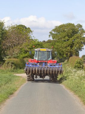 Tractor on a country road clipart