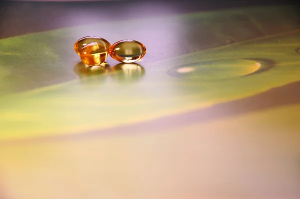 Желтые таблетки на зеленом фоне — стоковое фото
