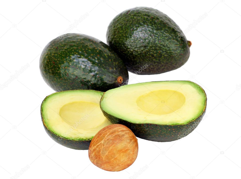 Avocados on white, cut and whole with pit.