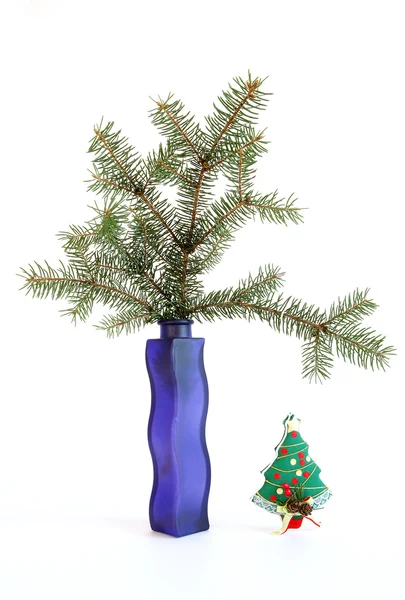Christmas decoration in colored glass vase on white background Stock Photo