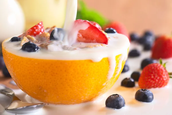 Pouring Milk Over Wholewheat Cereal with Fresh Fruits — Stock Photo, Image