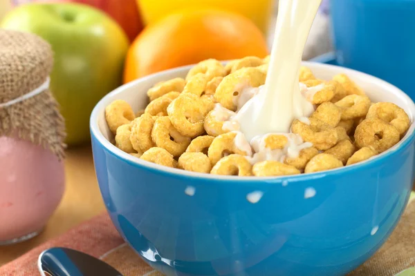 Pouring Milk Over Honey Flavored Cereal Loops — Stock Photo, Image