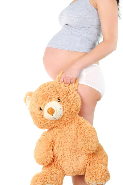 Zwangere vrouw met speelgoed van kind — Stockfoto