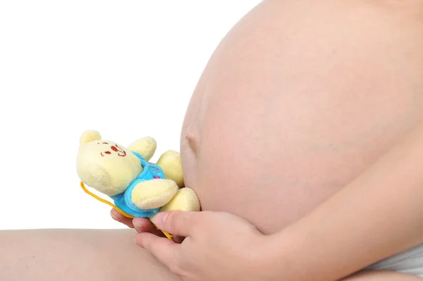 Kobieta w ciąży z zabawkami dziecka — Zdjęcie stockowe