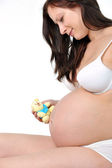 Pregnant woman with childs toy
