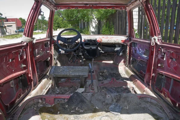 stock image Old rusty red car inside view