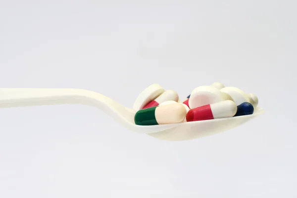Pills on spoon — Stock Photo, Image