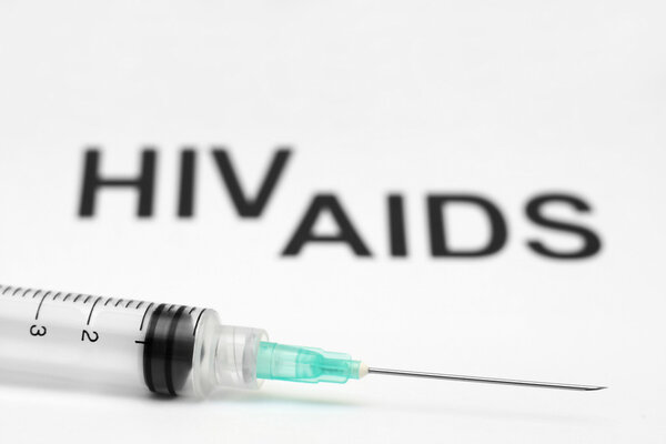 Syringe on Hiv - aids background