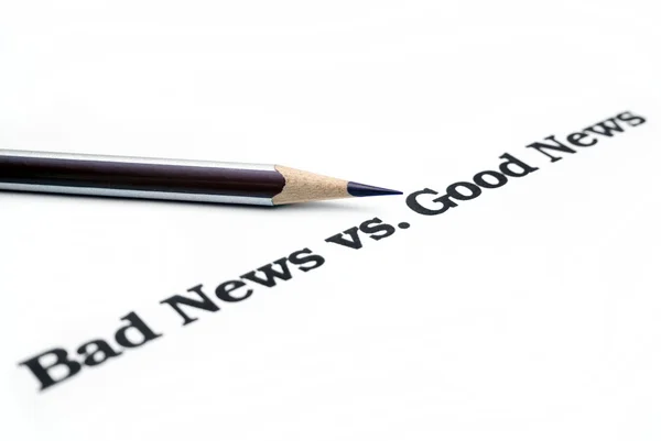 Dårlige nyheter versus gode nyheter – stockfoto