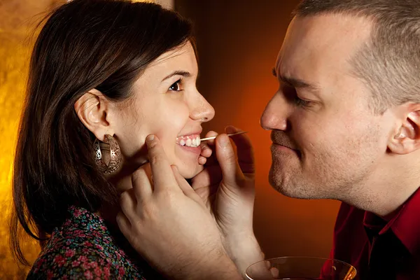 Men taking care of girlfriend's teeth — Stock Photo, Image