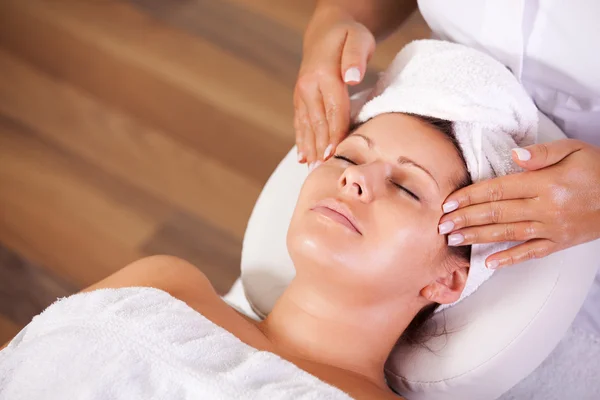 Young beautiful woman getting facial massage — Stock Photo, Image