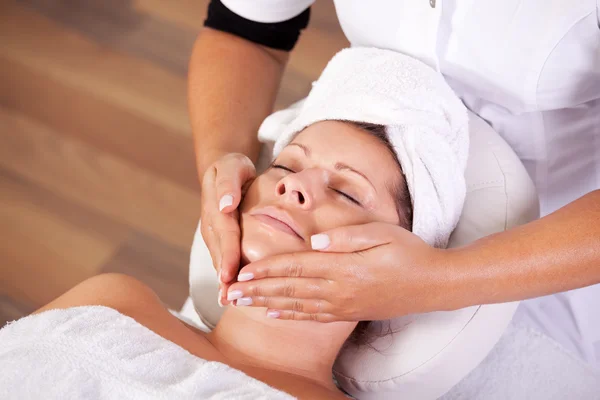 Young beautiful woman getting facial massage — Stock Photo, Image