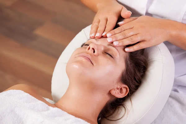 Young beautiful woman getting facial massage — Stock Photo, Image