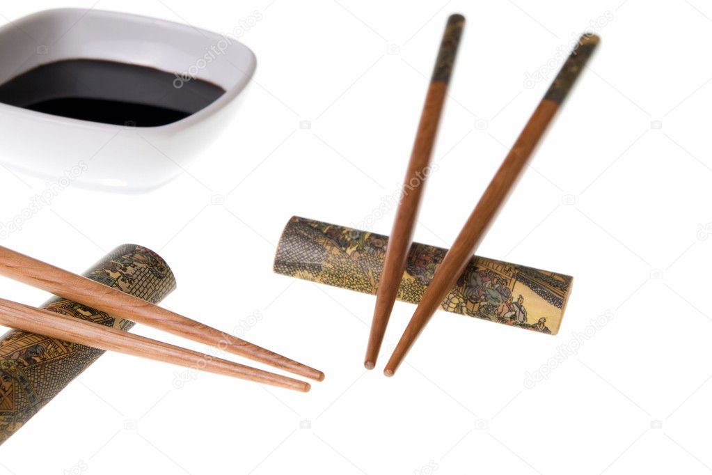 Two pairs of chopsticks and soy sauce