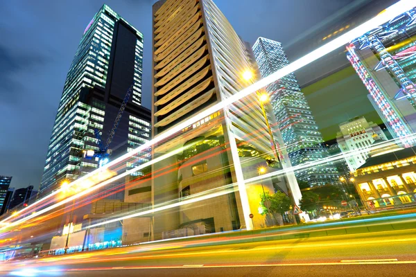 Light trails on the modern building background in Hong Kong — Stock Photo, Image