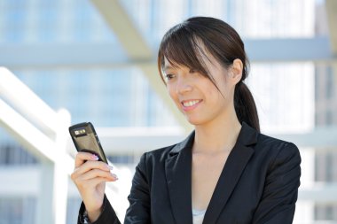 Business woman using mobile cell phone clipart