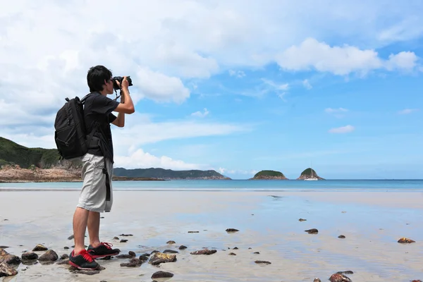 stock image Photographer taking photo on beach