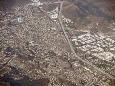 Highway stretches through LA and Mountains clipart