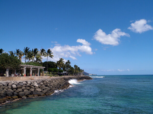 Wave crashes against rock seawall at Kaka`ako Waterfront Park