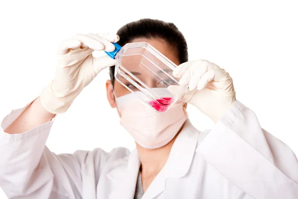Female scientist looking at tissue culture flask — Stock Photo, Image