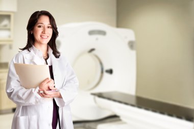 Female doctor radiologist at CT CAT scan with chart clipart
