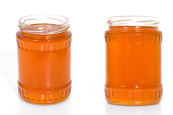 Frasco de mel no fundo branco — Fotografia de Stock
