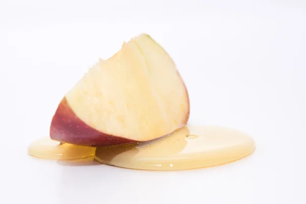 Med na červené jablko izolovaných na bílém — Stock fotografie