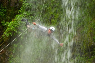 Canyoning Tour Leader Jumping Into A Waterfall