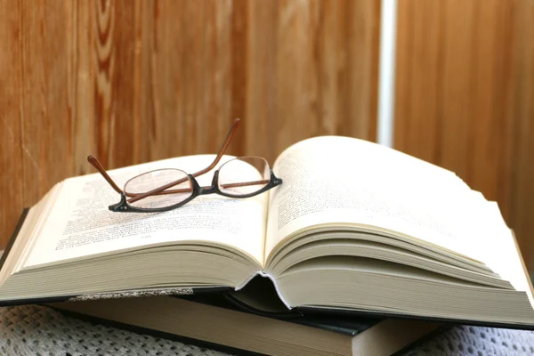 stock image Thick open book and glasses on it