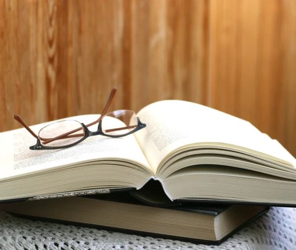 stock image Thick open book and glasses on it
