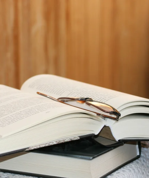 stock image Thick open book and glasses on it