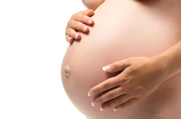 Bela barriga grávida nas mãos da mulher . — Fotografia de Stock