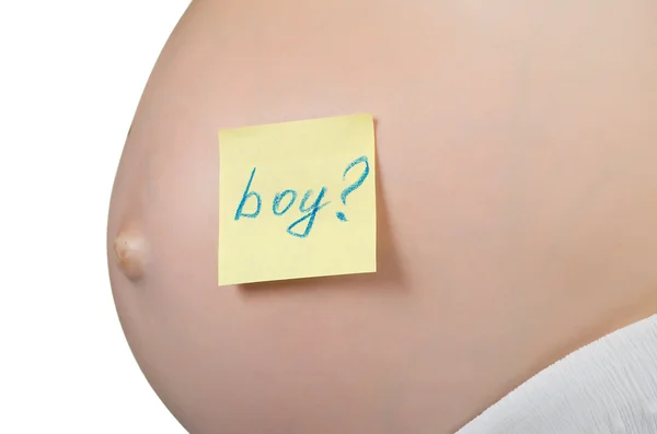 Pregnant woman with a sticky note saying Boy on her belly. — Stock Photo, Image